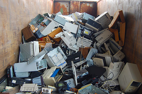 old computers stacked in a corner